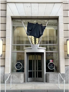 The U.S. Agency for International Development building with its lettering removed and insignia obscured. 